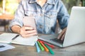 Business womenÃ¢â¬â¢s sitting in office and working her computer laptop on desk with using smartphone. Woman analyzing data Royalty Free Stock Photo